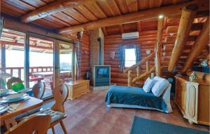 a bedroom in a log cabin with a bed and a staircase at Amazing Home In Novi Marof With Outdoor Swimming Pool in Novi Marof