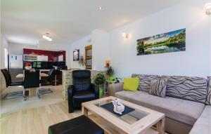 a living room with a couch and a table at Amazing Home In Ston With 3 Bedrooms, Wifi And Outdoor Swimming Pool in Ston