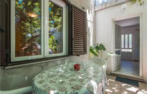 a room with a table and a window at 1 Bedroom Amazing Apartment In Mali Losinj in Mali Lošinj
