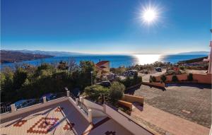 a view of the ocean from the balcony of a house at 1 Bedroom Awesome Apartment In Volosko in Volosko
