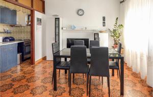 a dining room with a table and black chairs at 3 Bedroom Lovely Apartment In Sibenik in Šibenik