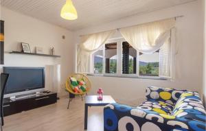 a living room with a couch and a tv at Lovely Home In Vela Luka With Kitchen in Vela Luka