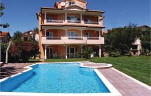 a house with a swimming pool in front of a house at 2 Bedroom Amazing Apartment In Novigrad in Novigrad Istria