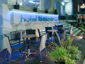 a group of tables and chairs in a hotel beater at Hotel Belmar in Cattolica
