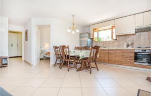 a kitchen and dining room with a table and chairs at Amazing Apartment In Vodice With Kitchen in Vodice
