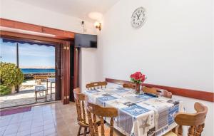 a dining room with a table and a view of the ocean at 2 Bedroom Lovely Apartment In Ribarica in Ribarica