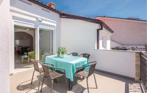 a patio with a table and chairs on a balcony at Awesome Apartment In Crikvenica With House A Panoramic View in Crikvenica