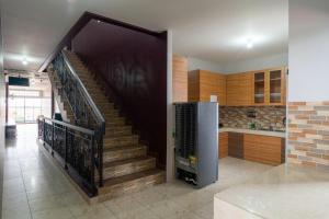 a kitchen with a staircase in a house at Brilliant Residence Gading Serpong RedPartner in Tangerang