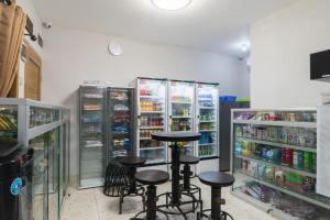 a store with stools in front of the refrigerator at Brilliant Residence Gading Serpong RedPartner in Tangerang
