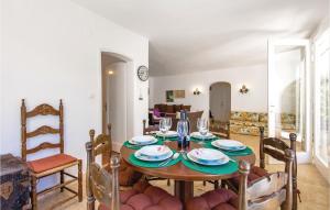a dining room with a table and chairs at 2 Bedroom Cozy Home In Kampor in Kampor