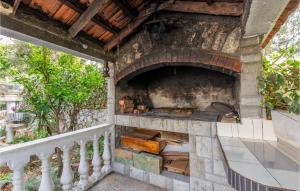 an outdoor pizza oven on a balcony at 4 Bedroom Awesome Home In Sevid in Sevid