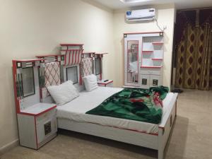 a bedroom with a bed in a room with shelves at Hotel Continental in Islamabad
