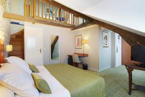 a bedroom with a large bed and a staircase at Lautrec Opera in Paris