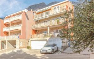 a car parked in front of a large building at Stunning Apartment In Baska Voda With Wifi in Baška Voda