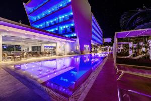 a swimming pool in the middle of a building at night at Seasons Hotel (Adults Only) in Ayia Napa