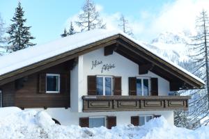 a house covered in snow with the words happy alpha written on it at Haus Alpina in Sonnenalpe Nassfeld