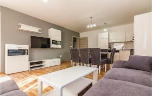 a living room with a couch and a table at Three-Bedroom Apartment In Medulin in Medulin