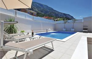 a swimming pool on the roof of a house at 3 Bedroom Gorgeous Home In Makarska in Makarska