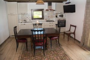 a kitchen with a dining room table and chairs at Villa Calabianca in Castellammare del Golfo