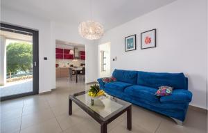 a living room with a blue couch and a glass table at Beautiful Apartment In Rabac With 2 Bedrooms And Wifi in Rabac