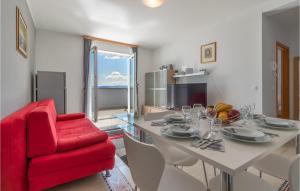 a living room with a table and a red chair at Pet Friendly Apartment In Selce With House Sea View in Selce