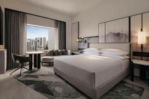 
a hotel room with a large bed and a large window at Hilton Singapore Orchard - SG Clean in Singapore

