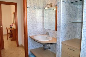 a bathroom with a sink and a mirror at Appartamento Agrusa in San Vito lo Capo