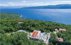 an aerial view of a house on a hill next to the water at Awesome apartment in Plomin with 1 Bedrooms, Jacuzzi and Outdoor swimming pool in Plomin