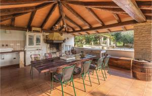 a large kitchen with a wooden table and chairs at Amazing Home In Medulin With Outdoor Swimming Pool in Medulin
