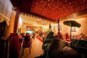 a living room with couches and a dining room at Wilbergerhof RoyalThai in Horn-Bad Meinberg