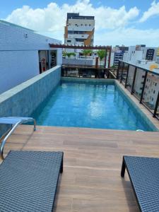 a swimming pool on the roof of a building at Flat Siberian 100m do mar in Cabedelo