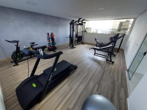 a gym with bikes and exercise equipment in a room at Flat Siberian 100m do mar in Cabedelo