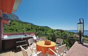 patio con mesa, sillas y bañera de hidromasaje en Amazing Home In Tucepi With Jacuzzi en Tučepi