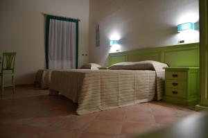 A bed or beds in a room at B&B Al Tramonto Portopalo