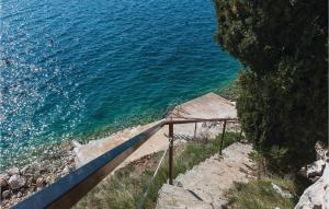 a set of stairs leading down to the water at Two-Bedroom Apartment In Brodarica in Brodarica