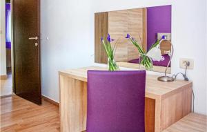 a purple desk with a purple chair in front of a mirror at Lovely Apartment In Grebastica in Grebaštica +14 photos