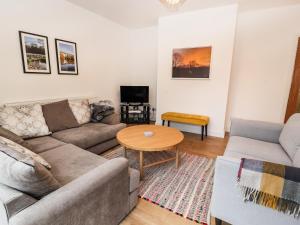 a living room with a couch and a table at Hillcrest in Wrexham