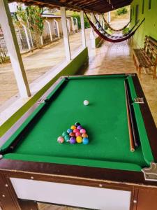 a pool table with balls on top of it at Pousada Recanto Dos Tucanos in Capitólio