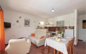 a kitchen and a living room with a table and a couch at Beautiful Home In Blato With 2 Bedrooms And Wifi in Blato