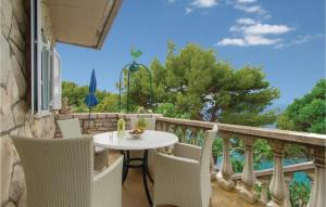 a patio with a table and chairs on a balcony at Beautiful Home In Blato With 2 Bedrooms And Wifi in Blato