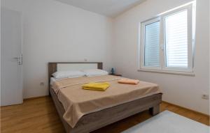 a bedroom with a bed with two towels on it at 2 Bedroom Amazing Apartment In Klek in Klek