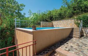 a swimming pool in a backyard with a fence at Cozy Home In Labin With Wifi in Drenje