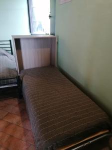 a bed sitting in a corner of a room at Casale Poggio Meone in Santa Luce