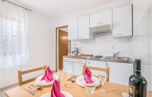 a kitchen with a table with a bottle of wine at Beautiful Apartment In Jurandvor With Kitchen in Jurandvor