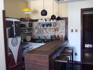 a kitchen with a refrigerator and a counter top at Flat Apart Hotel Ondina Barra em Salvador in Salvador