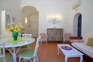 a living room with a table and a couch at Braschi Amalfi Dreams in Minori