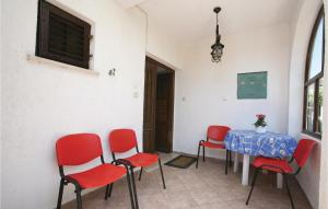 a room with a table and red chairs at 2 Bedroom Gorgeous Apartment In Labin in Raša