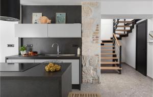 a kitchen with a sink and a staircase at Stunning Home In Medulin With Wifi in Medulin