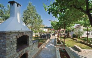 a brick oven in a yard with a sidewalk at 3 Bedroom Nice Apartment In Fazana in Fažana