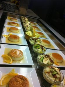 a bunch of plates of food on a table at Hotel Emilio Moretti in Laayoune